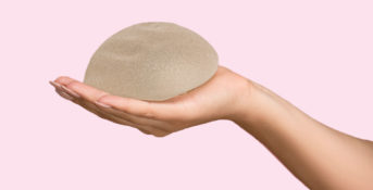 hand holding a breast implant