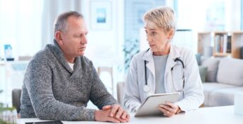 A patient talks with his doctor